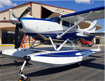 Small airplane in front of building