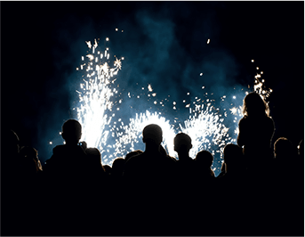 Silhouettes of a group holding sparklers