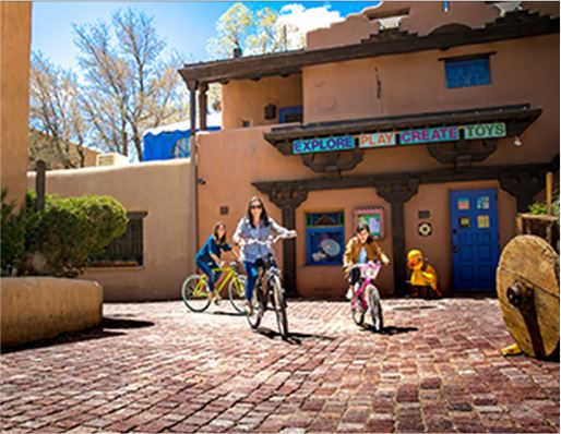 Family riding bikes down the street
